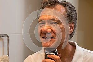 Man Shaving with an Electric Razor or Shaver