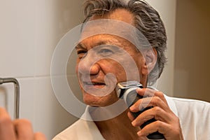 Man Shaving with an Electric Razor or Shaver