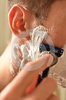 Man shaving with a razor morning routine