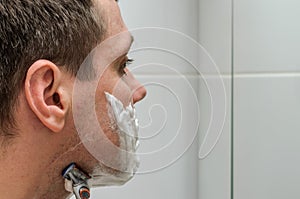 Man shaving razor and shaving foam in the bathroom