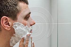 Man shaving razor and shaving foam in the bathroom