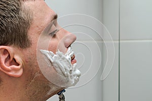 Man shaving razor and shaving foam in the bathroom