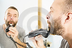 Man shaving trimming his beard