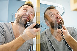 Man shaving trimming his beard