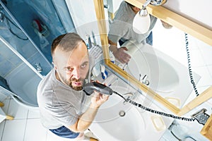 Man shaving trimming his beard