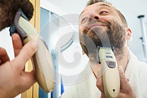Man shaving trimming his beard