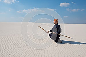 Man with shinai in traditional Japanese clothes took the position