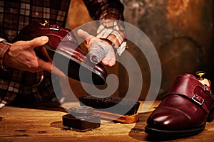 Man shining shoes with a rag.