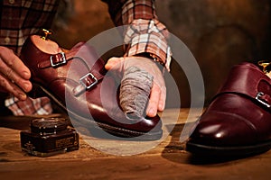 Man shining shoes with a rag.