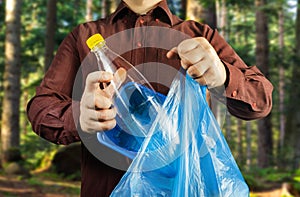 Man in shirt disposing plastic bottle and can