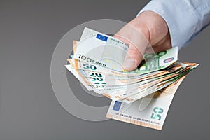 Man in shirt holding euro money in his hands. Banking, salary and donate concept.