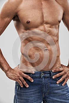 Man, shirtless and abs or bodybuilder pride in studio, body and fitness by white background. Male person, wellness and