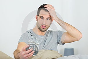 man shocked as he wakes up late for work