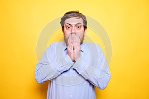 Man shocked covering mouth with hands for mistake. Secret concept
