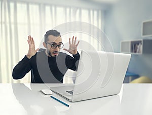 Man Shocked Reading Message on Computer in Office