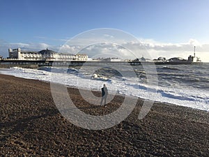 A man shooting from beach of Brighton Palace Pier. photo
