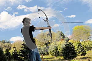 Man shooting bow and arrow