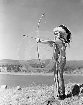 Man shooting with bow and arrow