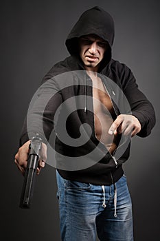 Man shooting gun isolated on gray