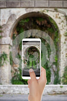 A man shooting a photo of cave near Terrazza del Pincio