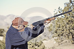 Man Shooting a Shotgun Hunting photo