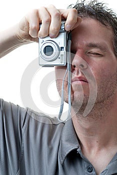 Man shooting with small digital camera on white