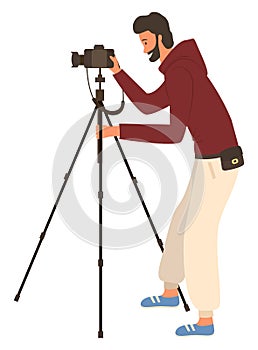 Man Shooting Videos or Photos by Camera on Tripod