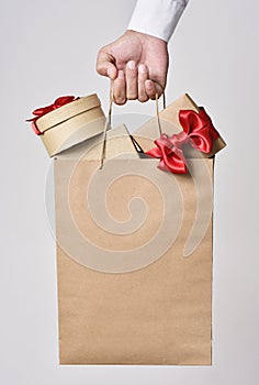 Man with a shopping bag full of gift boxes