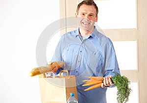 Man with shopping bag at home
