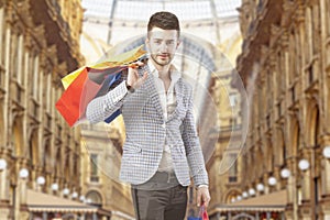 Man with shopping bags in Vittorio Emanuele Gallery, in Milan