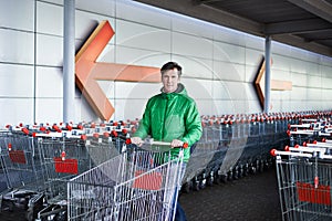 Man with shopping cart on parking