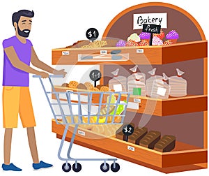 Male looking at bakery in hypermarket. Man with shopping cart chooses pastries at grocery store