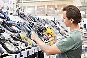 Man shopping drill in hardware store