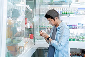 A man shopping for drugs in a pharmacy, Medical healthcare concept