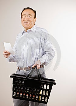 Man shopping for groceries with shopping list