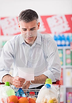 Man shopping with a grocery list