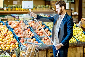 Man with shopping list in the supermarket