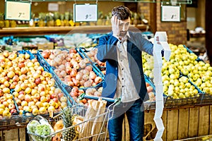 Man with shopping list in the supermarket