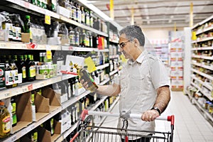 Man shopping and looking at food in supermarket