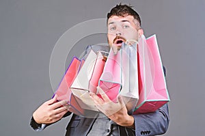 Man in shopping mall. stylish esthete with shopping bag. heavy bags. Mature shopaholic. holiday purchase. business. Big