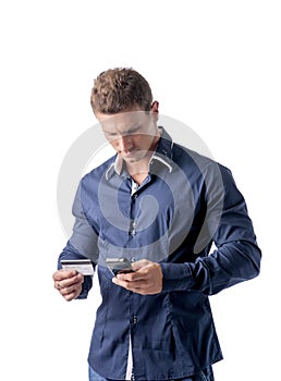 Man shopping online on mobile phone, holding credit card