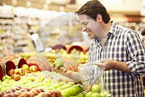 Man Shopping For Produce In Supermarket