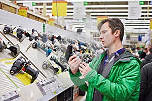 Man shopping for screwdriver in hardware store