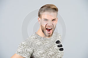 Man shout angry in tshirt on grey background