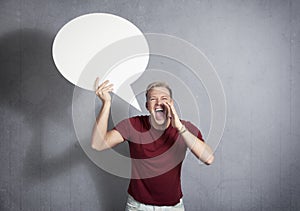 Man shouting with empty speech ballon in hand. photo