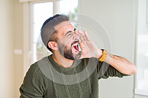 Man shouting with rage covering mouth with hands, yelling frustrated and crazy