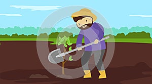 A man with a shovel digs a hole in the ground.