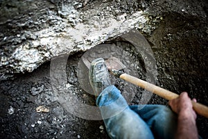 Man with shovel working at a hole