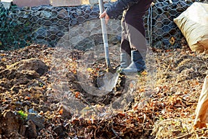 Man shoveling ground for landscape repair