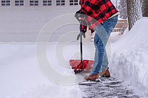 Man shoveling heavy snow in the driveway